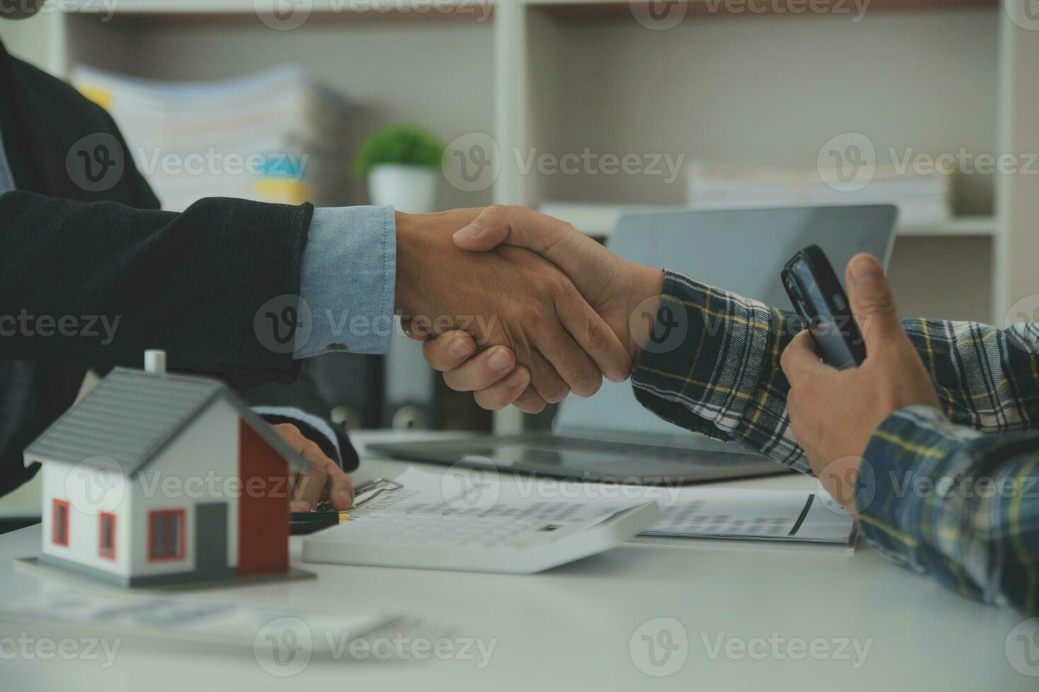 Real estate agent and customer signing contract to buy house, insurance or loan real estate.rent a house,get insurance or loan real estate or property. photo