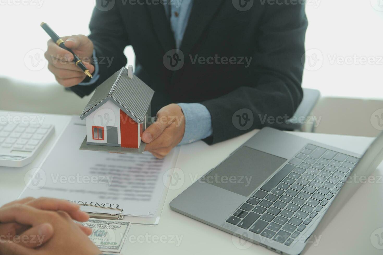 Real estate agent and customer signing contract to buy house, insurance or loan real estate.rent a house,get insurance or loan real estate or property. photo