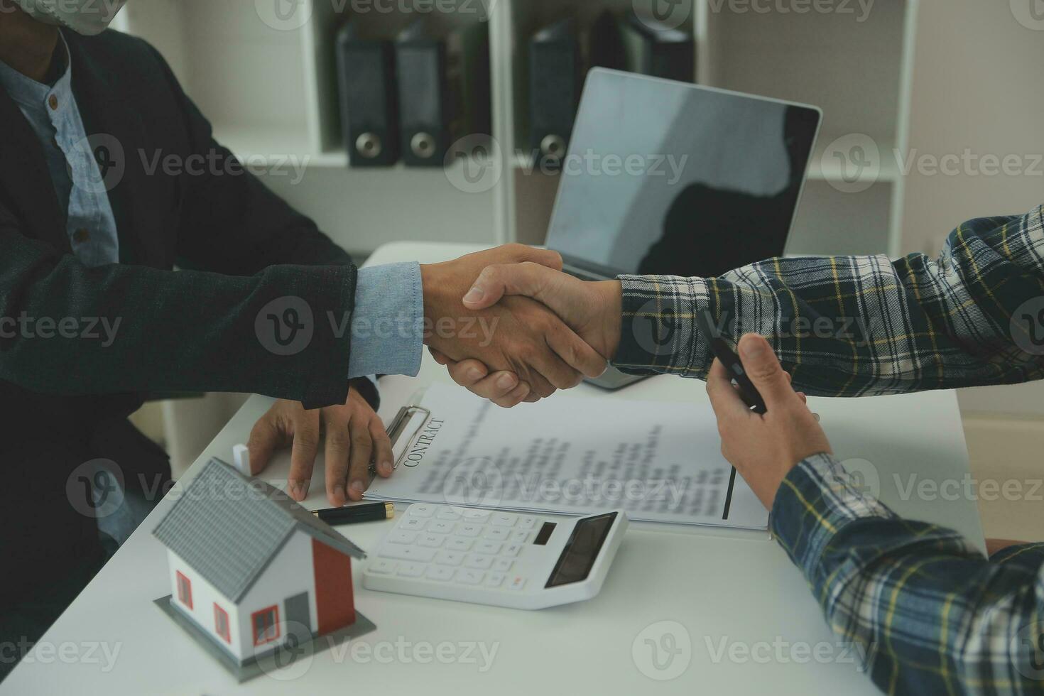 Real estate agent and customer signing contract to buy house, insurance or loan real estate.rent a house,get insurance or loan real estate or property. photo