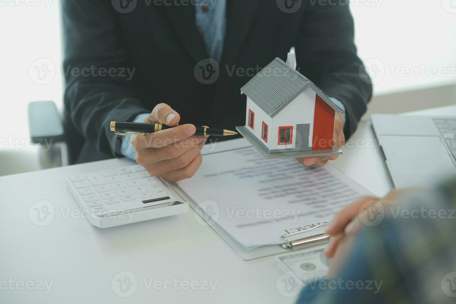 Real estate agent and customer signing contract to buy house, insurance or loan real estate.rent a house,get insurance or loan real estate or property. photo