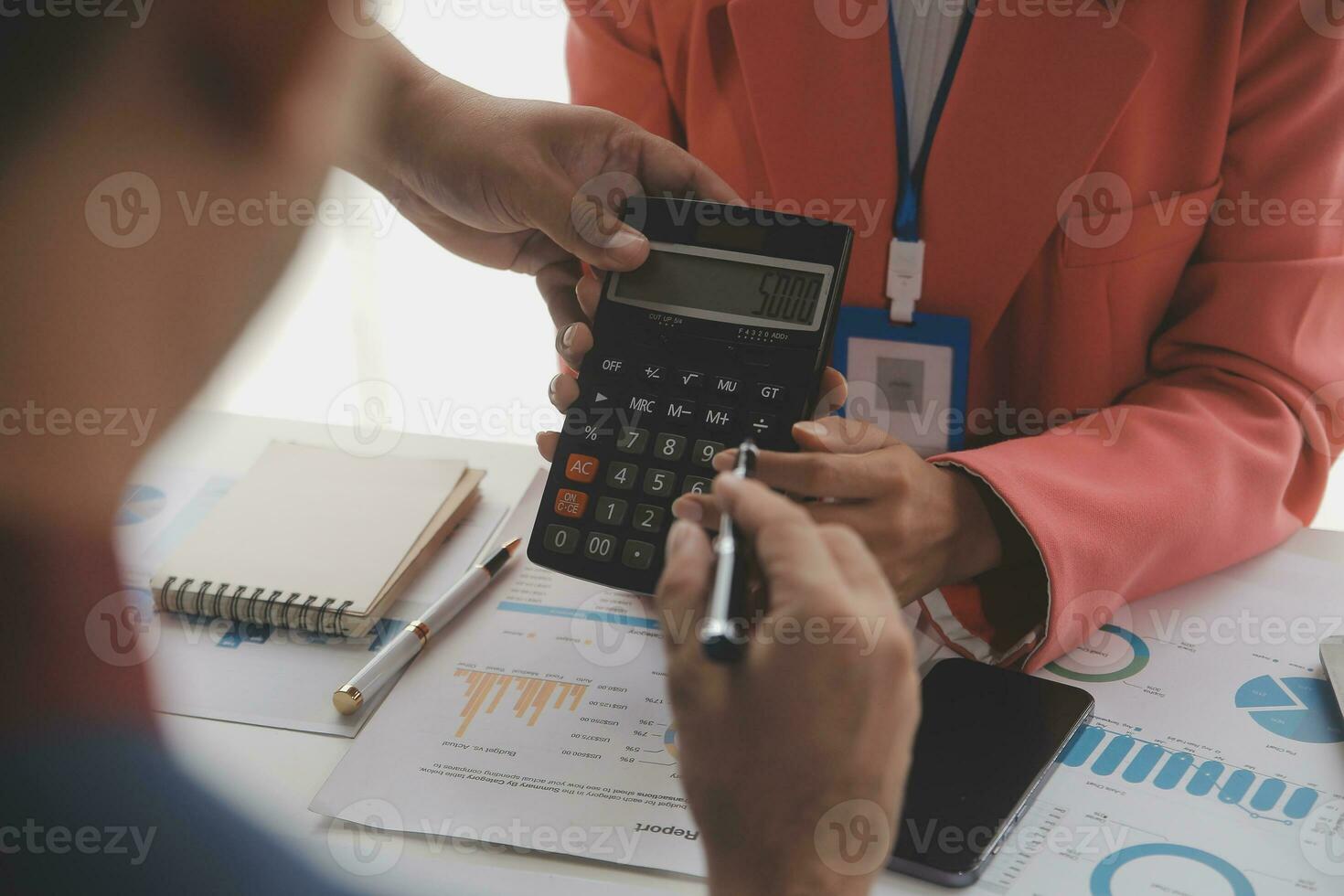 Close up Business woman using calculator and laptop for do math finance on wooden desk, tax, accounting, statistics and analytical research concept photo