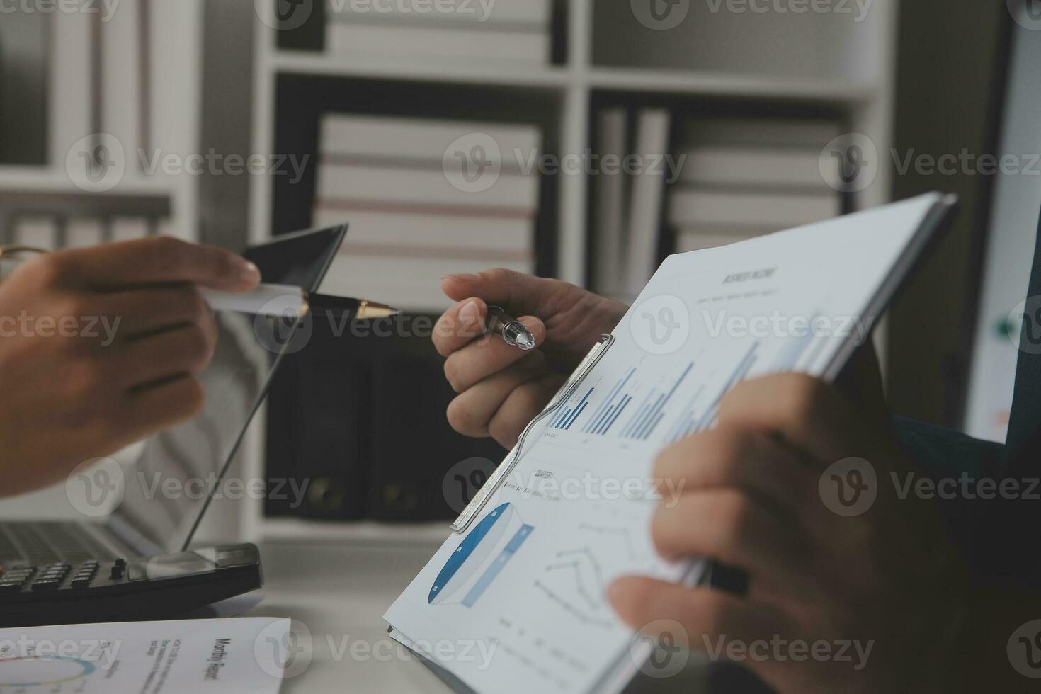 Close up Business woman using calculator and laptop for do math finance on wooden desk, tax, accounting, statistics and analytical research concept photo