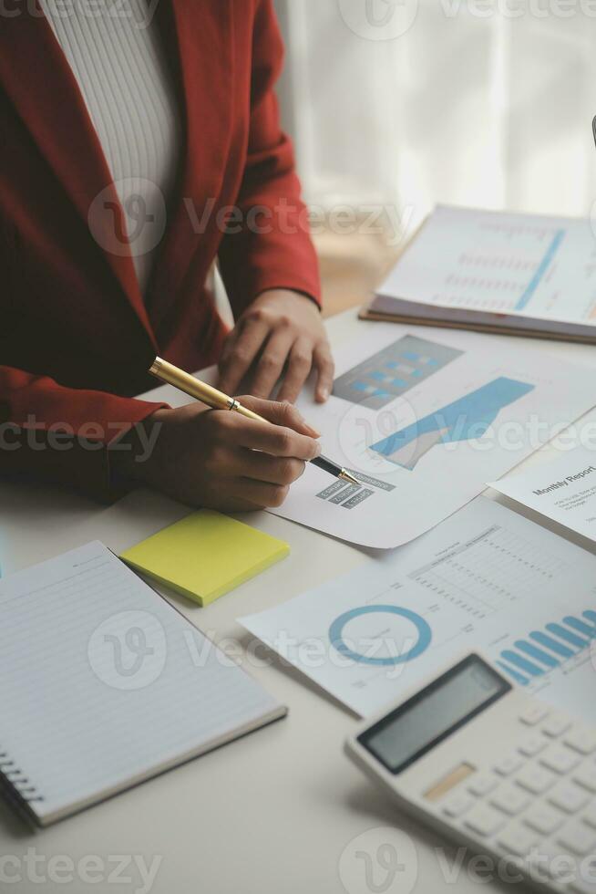 Close up Business woman using calculator and laptop for do math finance on wooden desk, tax, accounting, statistics and analytical research concept photo