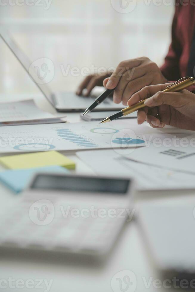Close up Business woman using calculator and laptop for do math finance on wooden desk, tax, accounting, statistics and analytical research concept photo