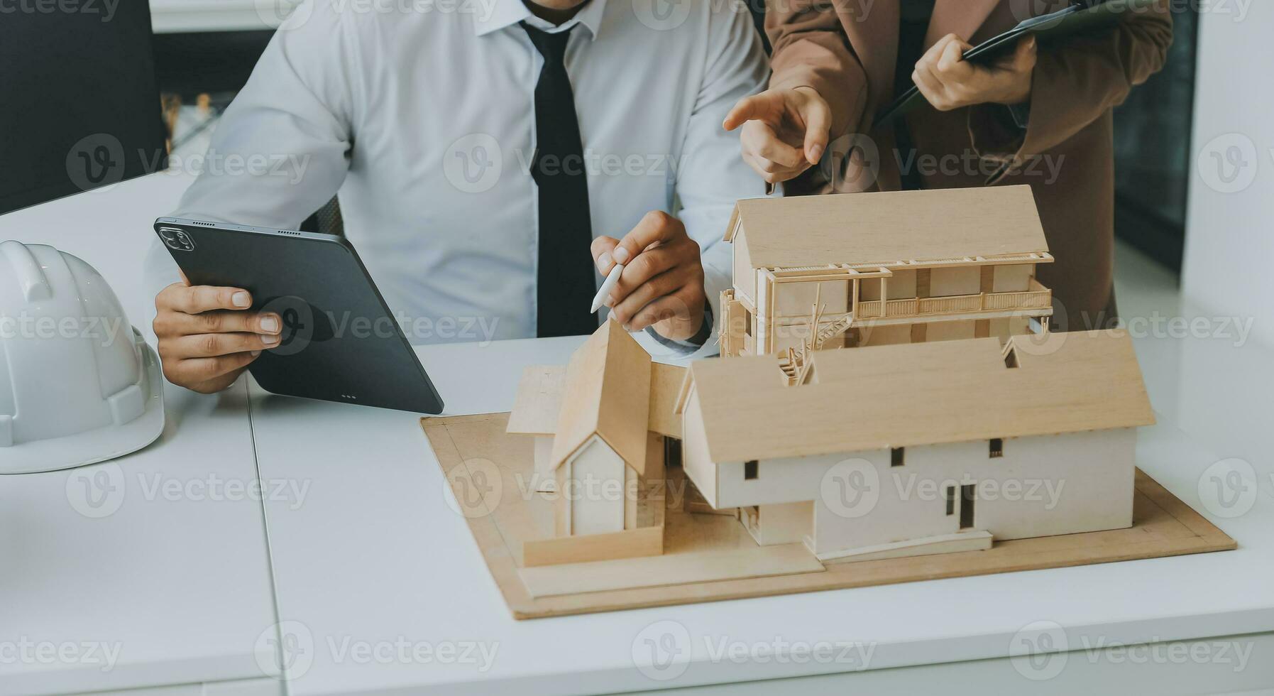 Construction and structure concept of Engineer or architect meeting for project working with partner and engineering tools on model building and blueprint in working site, contract for both companies. photo