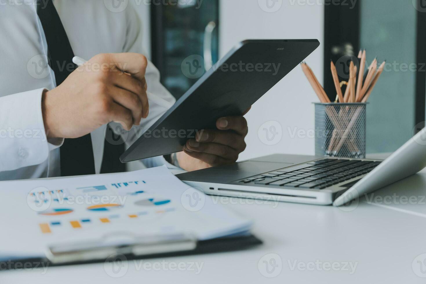 Close up of Business team analyzing income charts and graphs with modern laptop computer. Business analysis and strategy concept. photo