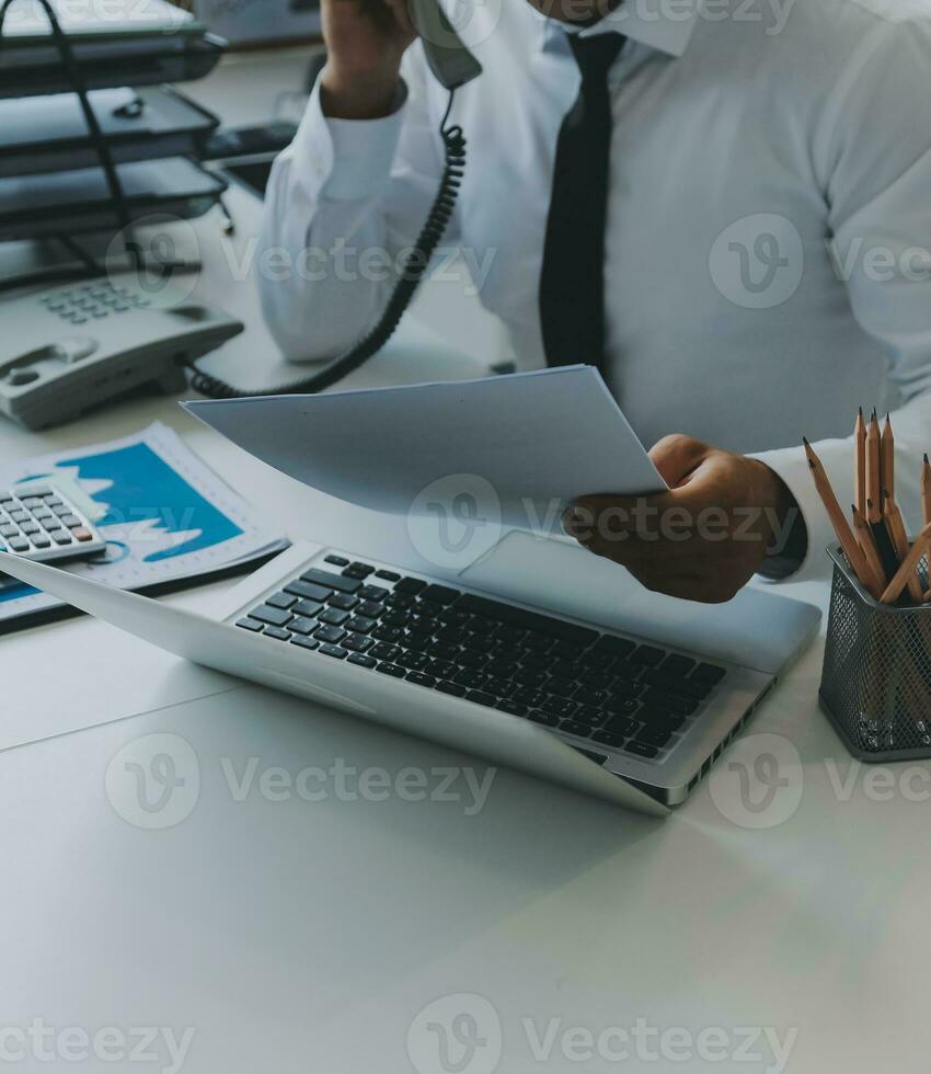 Close up of Business team analyzing income charts and graphs with modern laptop computer. Business analysis and strategy concept. photo