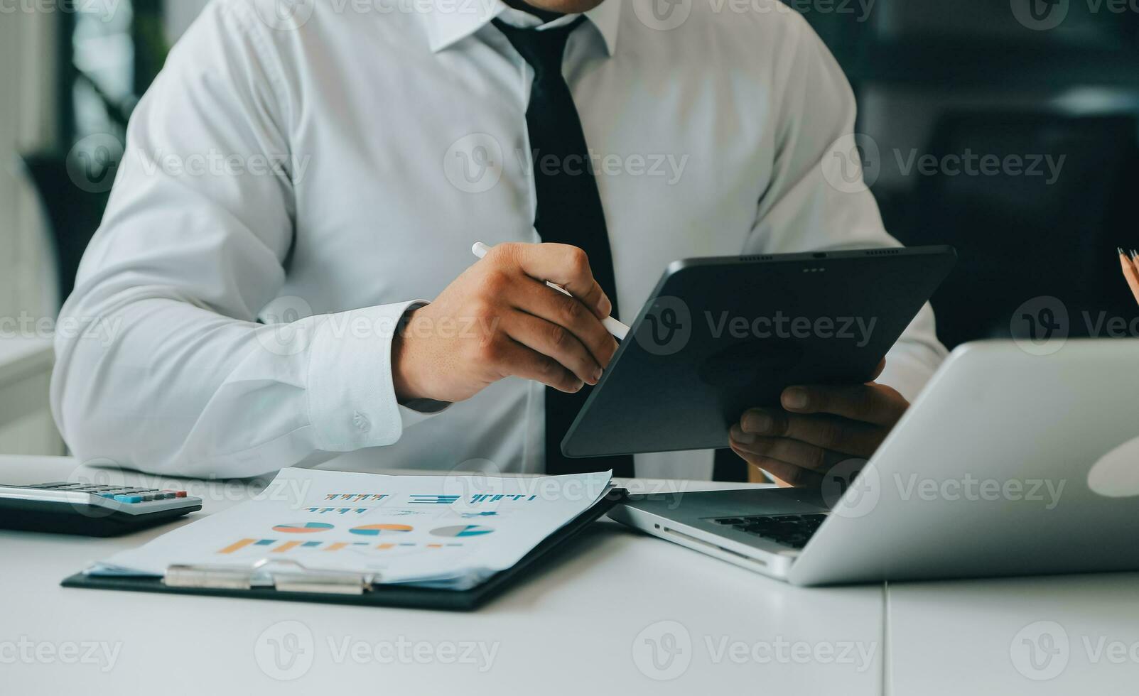 Close up of Business team analyzing income charts and graphs with modern laptop computer. Business analysis and strategy concept. photo
