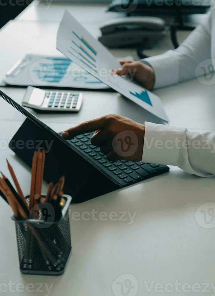 Close up of Business team analyzing income charts and graphs with modern laptop computer. Business analysis and strategy concept. photo