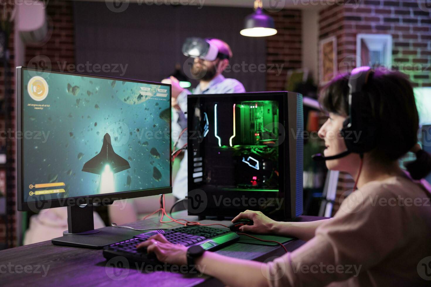 Professional gamer engaging in online competitive multiplayer tournament using cutting edge PC, captivating viewers during live stream. Woman in rgb lights lit home playing videogames photo