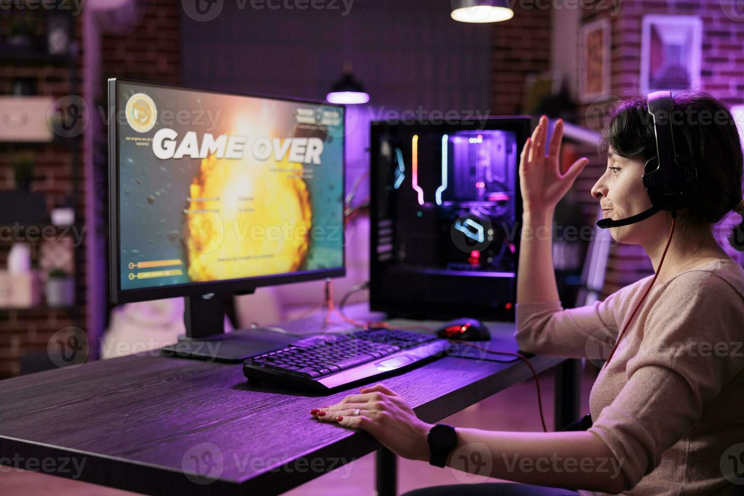 Frustrated gamer losing singleplayer spaceship arcade racing videogame, seeing game over screen on gaming computer display. Woman being dissapointed after being defeated on difficult game level photo