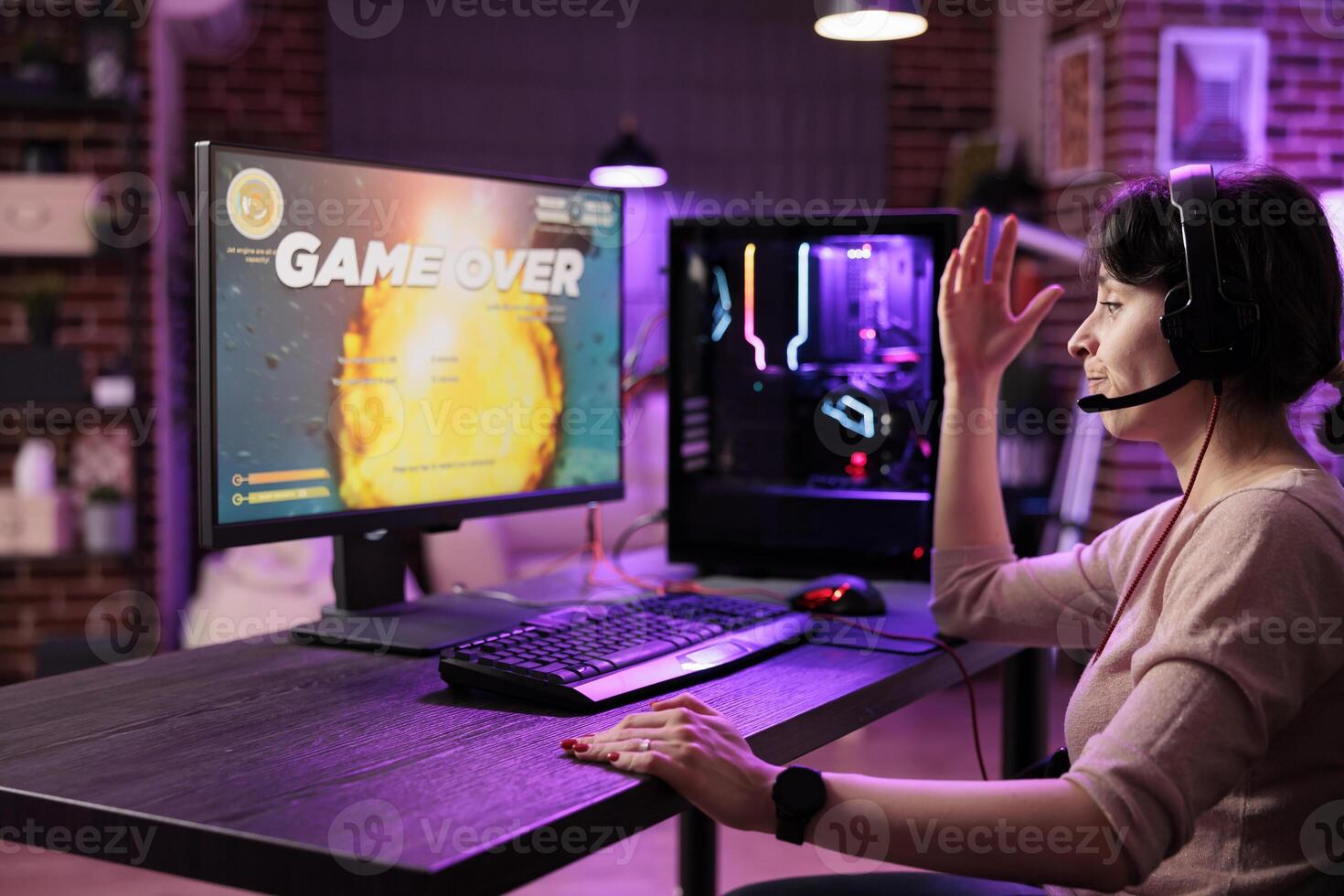 Frustrated gamer losing singleplayer spaceship arcade racing videogame, seeing game over screen on gaming computer display. Woman being dissapointed after being defeated on difficult game level photo