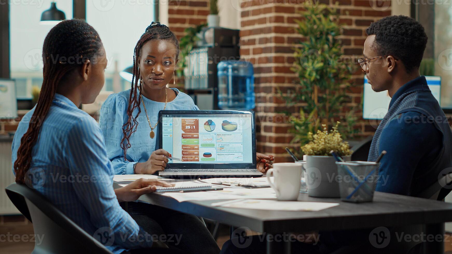 Startup team working on new vision, brainstormng ideas to obtain global development. Company workers reading annual data reports papers in boardroom meeting space, research group. photo