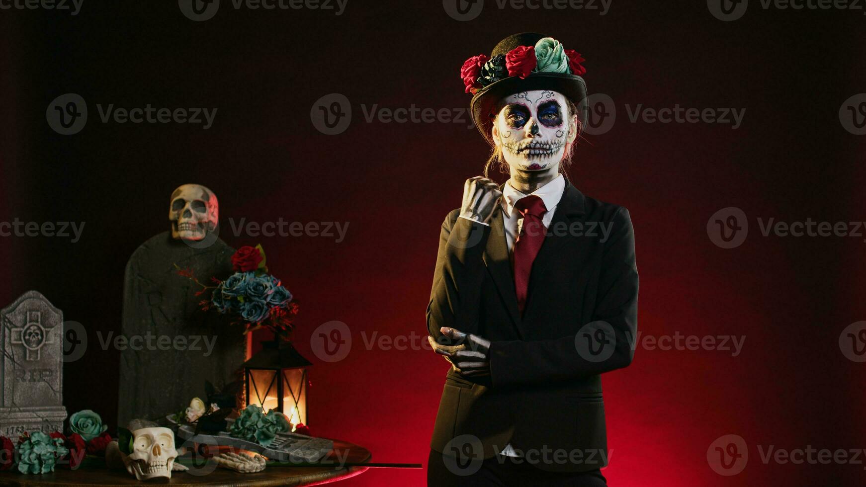 Creepy model in costume with skull make up celebrating mexican halloween, looking like lady of death. La cavalera catrina holy culture celebration with black and white body art. photo