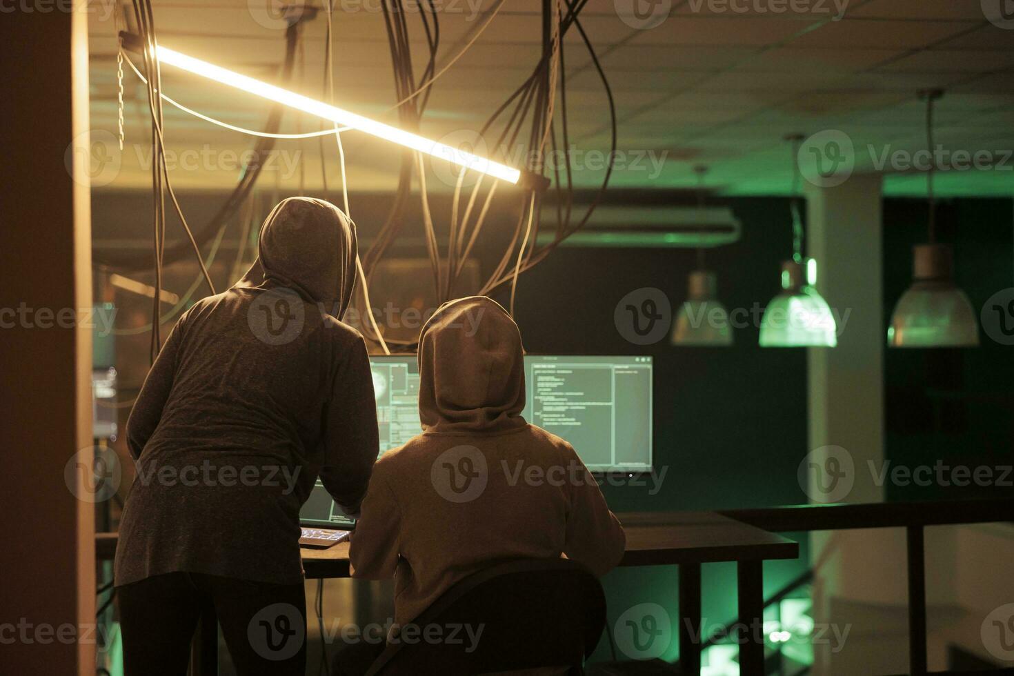 Diverse thieves attacking database passwords and security encryption to access server and steal information for ransom. Two hackers working together on phishing and identity theft. photo