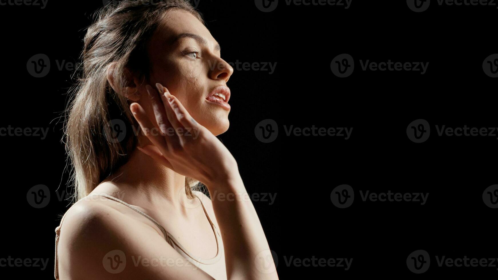 Woman with glamourous style doing beauty campaign and posing on camera for skincare products ad. Young female model acting confident and gentle, being sensual with beauty routine. photo