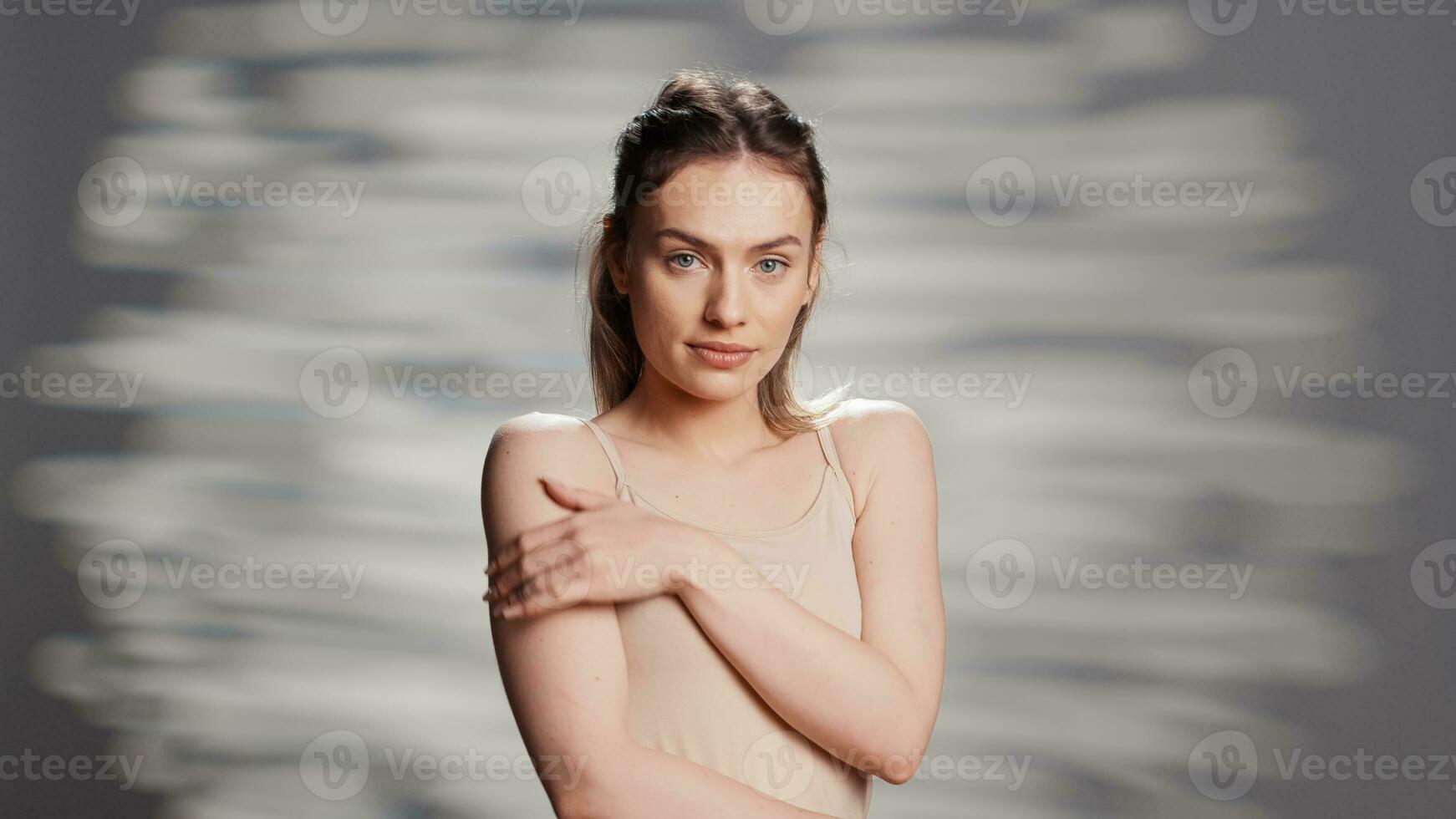Positive confident lady posing with luminous bare skin, advertising empowering beauty cosmetics for skincare ad campaign. Smiling happy girl glowing on camera, feeling sensual. photo