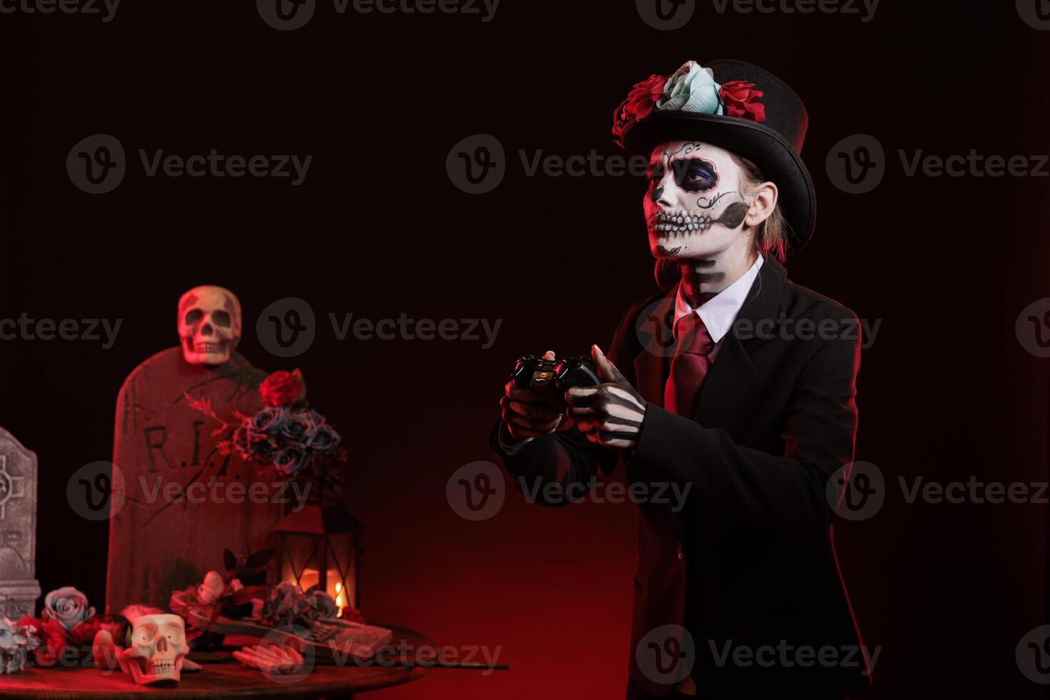Woman with santa muerte make up playing video games in studio, wearing halloween costume of mexican holiday tradition. Using controller to play on gaming console, dios de los muertos. photo