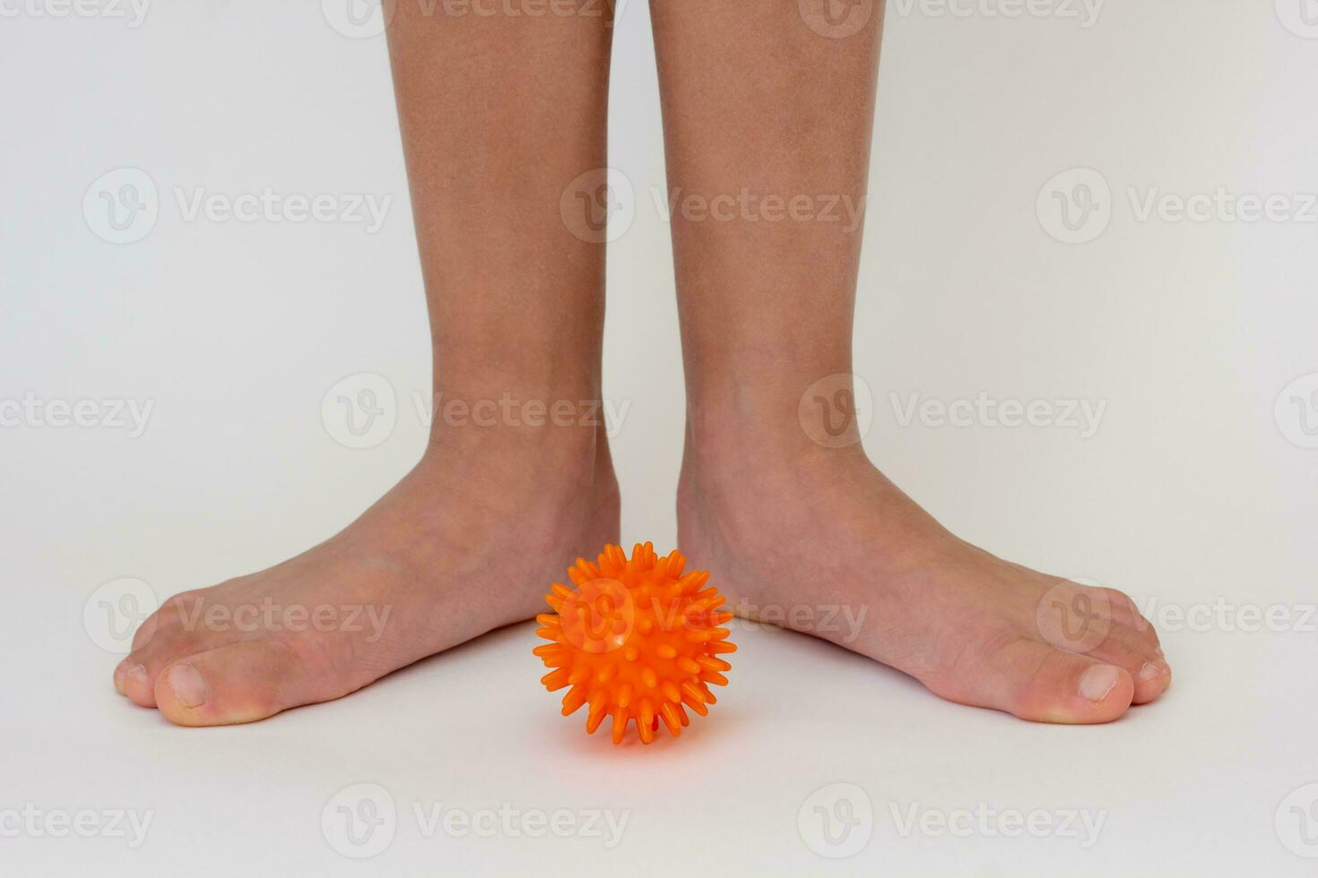 Cropped child legs and spiky needle ball photo