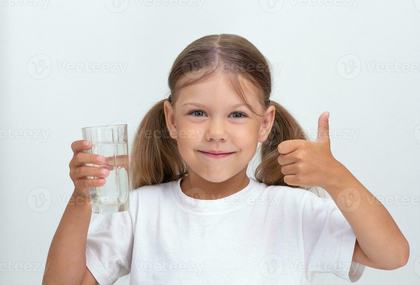 Child holding glass of water on white background photo