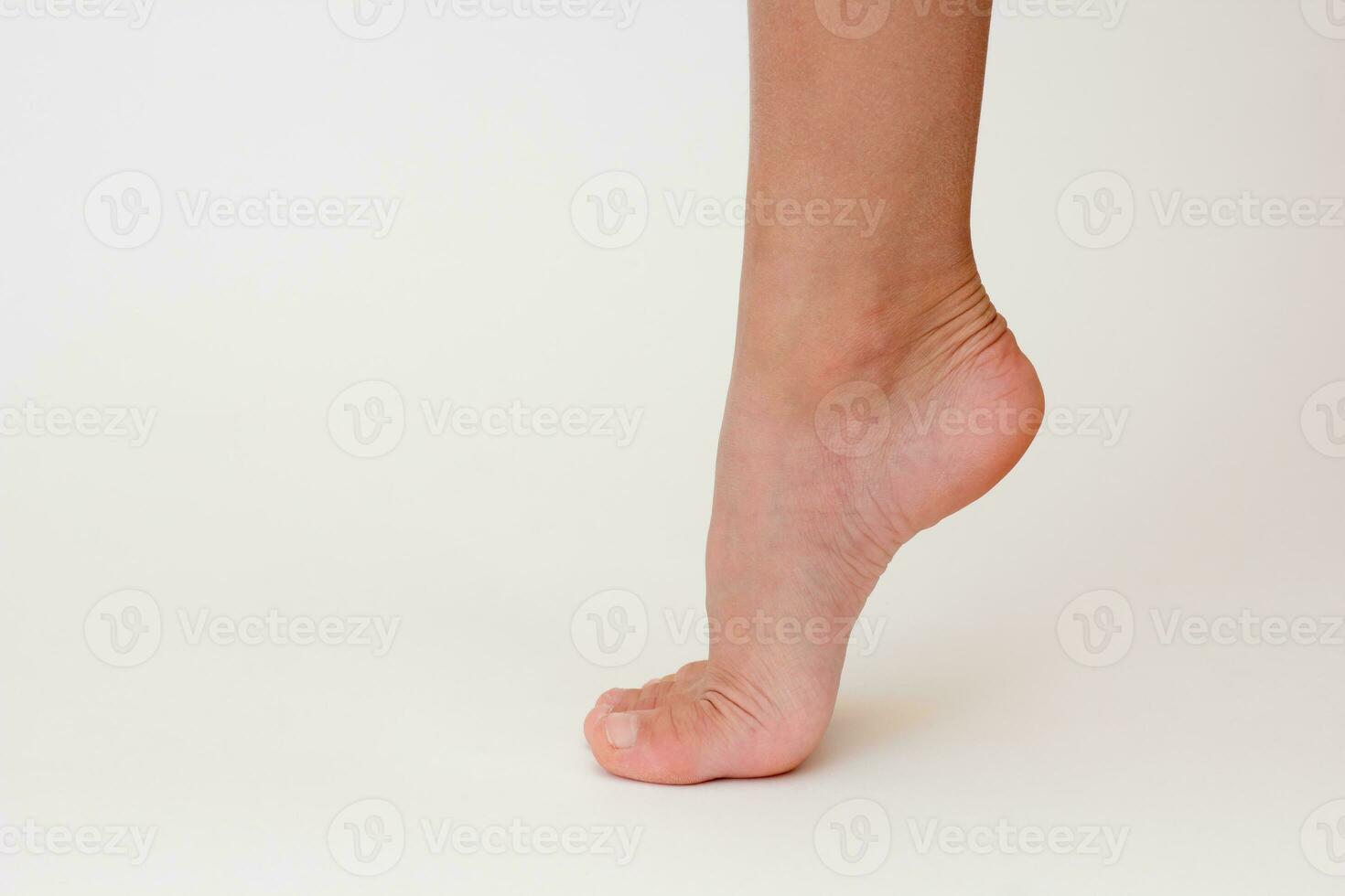 Cropped child leg with lifted heel photo