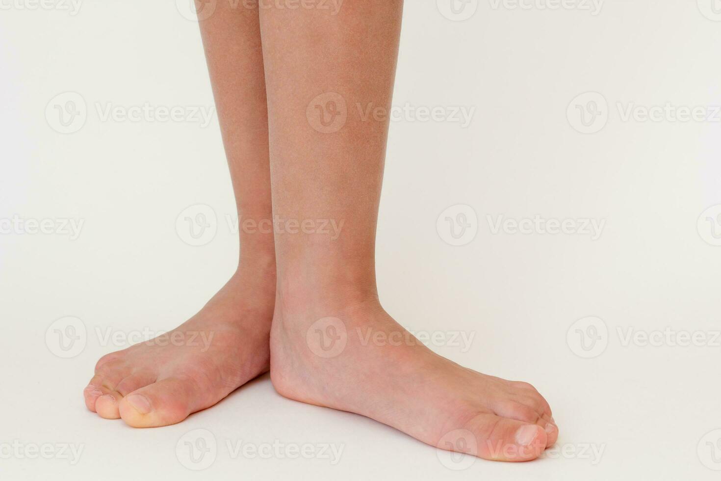 Cropped barefoot child legs photo