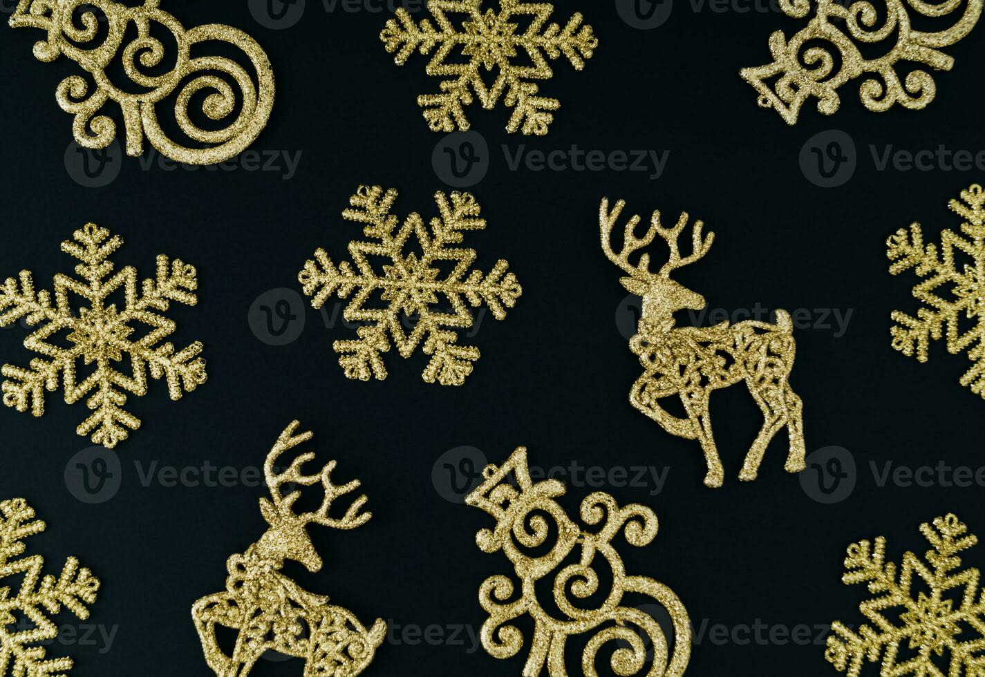 Trendy Christmas background pattern composition made with various golden Christmas decoration objects.  Minimal Xmas or New Year concept. Fancy winter holidays idea. Christmas aesthetic. Flat lay. photo