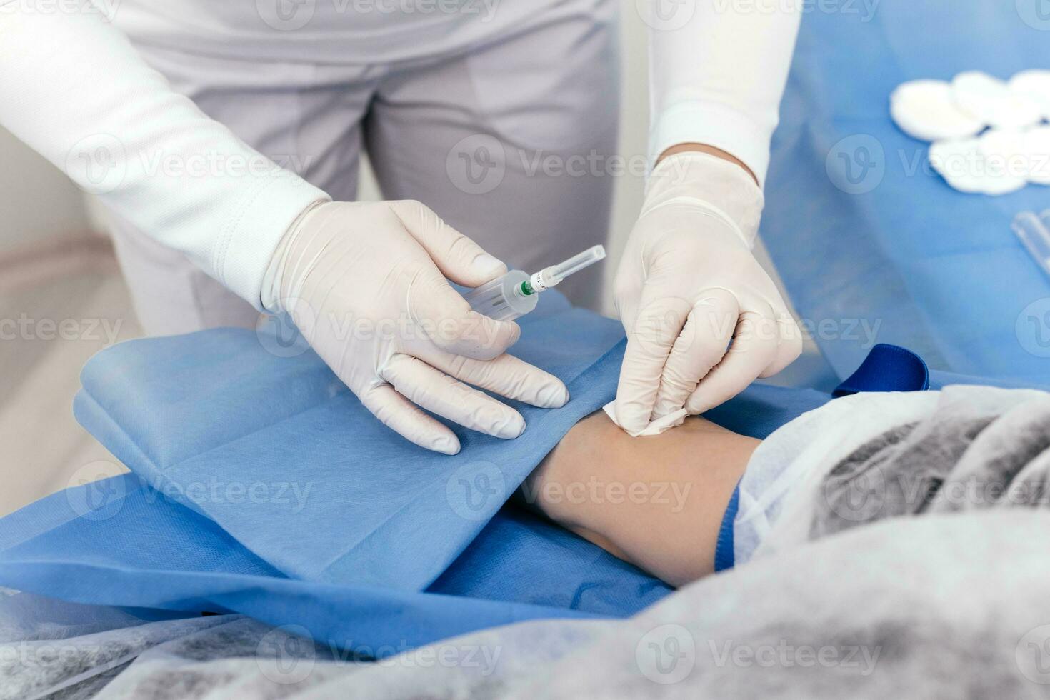 Laboratory worker doctor takes a blood sample for analysis, hand closeup. Blood sampling in the laboratory. Taking a blood in cosmetology clinic before PRP therapy procedure photo