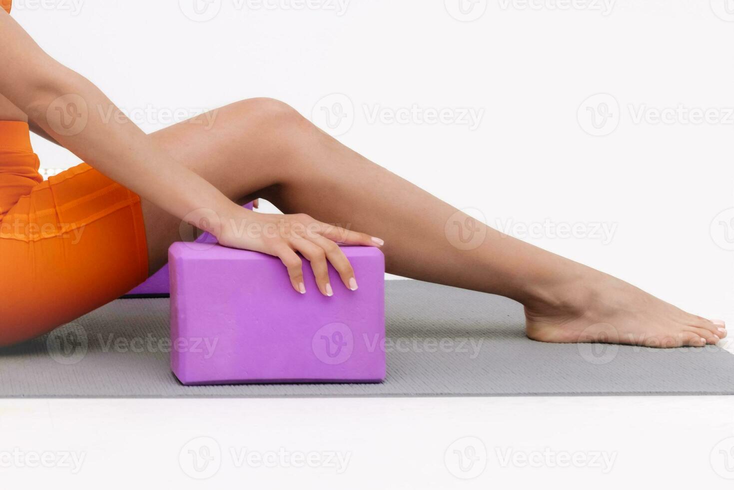 Young attractive woman practicing yoga stretching isolated on white background. Concept of healthy life and natural balance between body and mental development photo