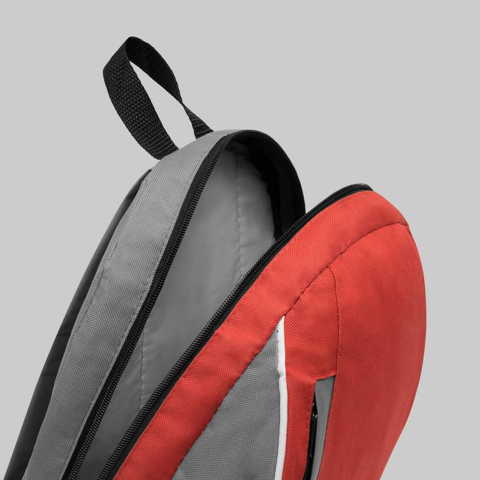 close up blank backpack with zipper and shoulder straps isolated on white background. travel day pack rucksack. folding nylon school backpack. top view. mock up. photo