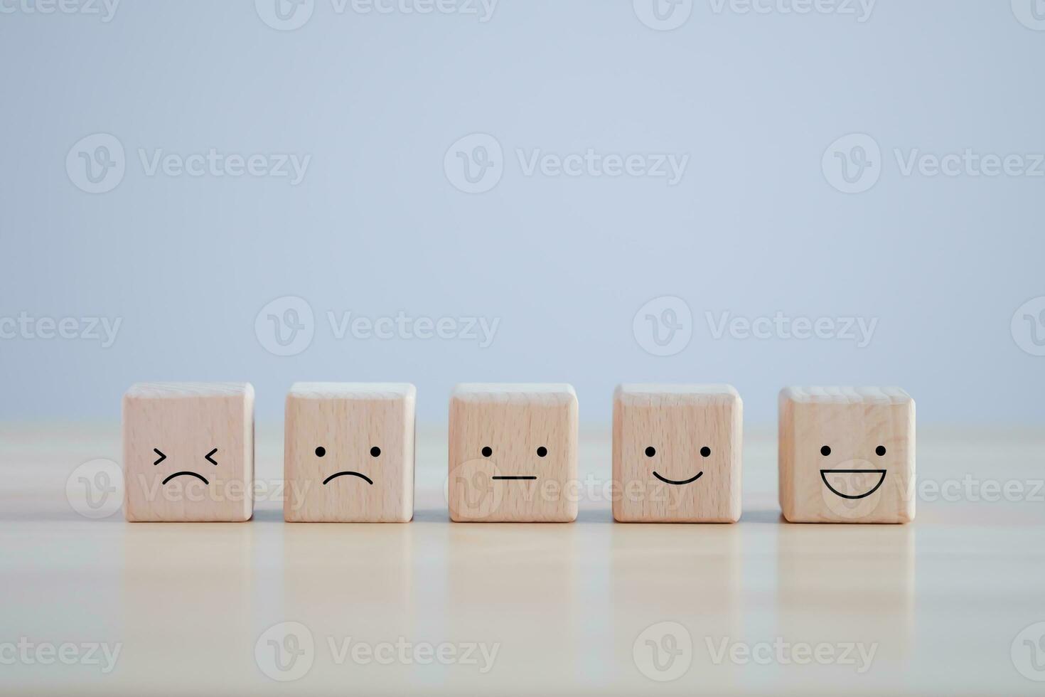 Wood cube with smile, normal and sad face. Facial expressions. Mental health assessment. World mental health day, Customer service rating experience, feedback emotion and satisfaction survey concept. photo