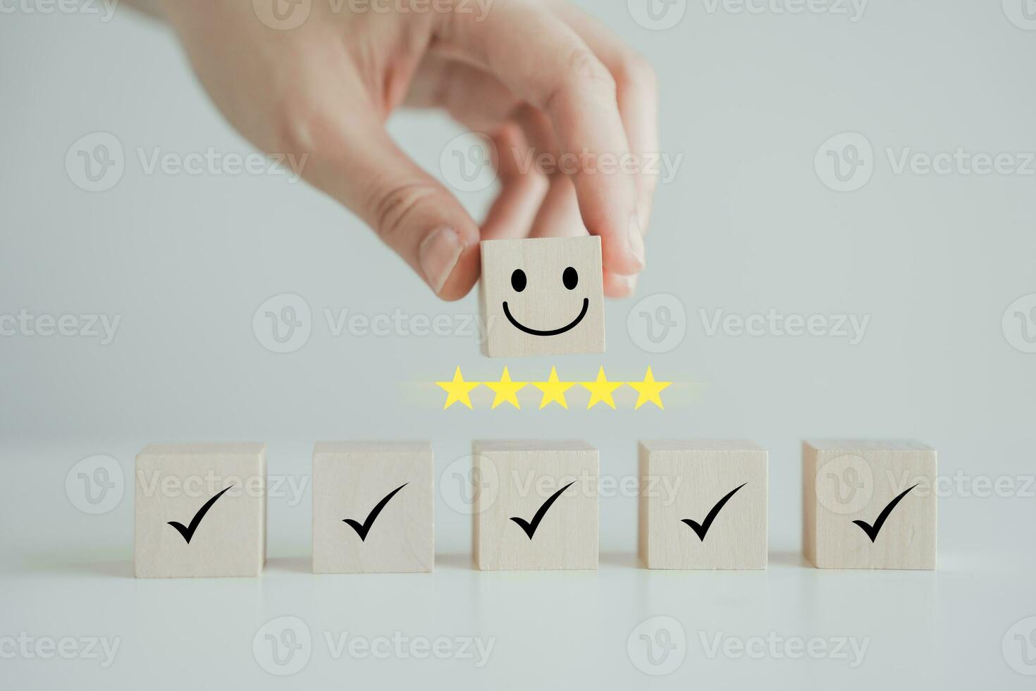 Hand holding smile happy face with 5 star and check mark on wooden block. Feedback rating and positive service review, Customer experience, World mental health day, Emotion, Satisfaction survey. photo