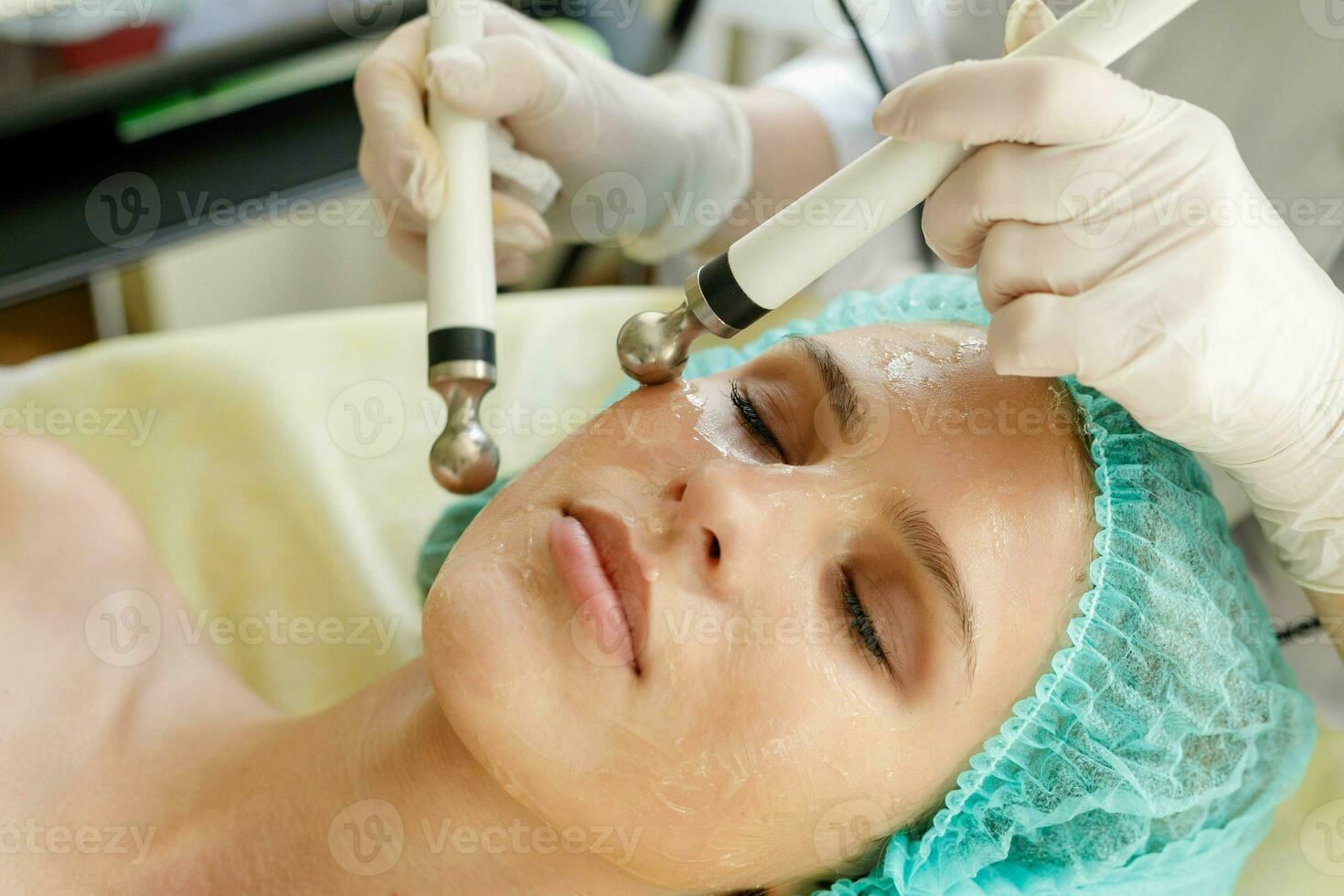 Cosmetologist makes the procedure microcurrent therapy beauty salon photo