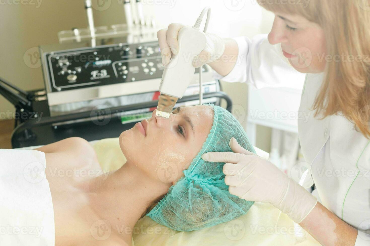 The cosmetologist makes the procedure ultrasonic face photo