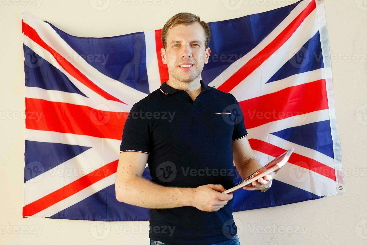 Portrait of young man against British flag photo