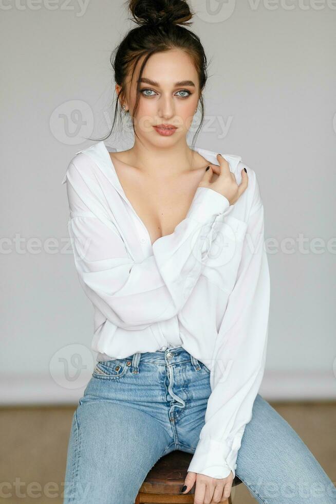portrait of seated young woman wearing a bouffant shirt photo