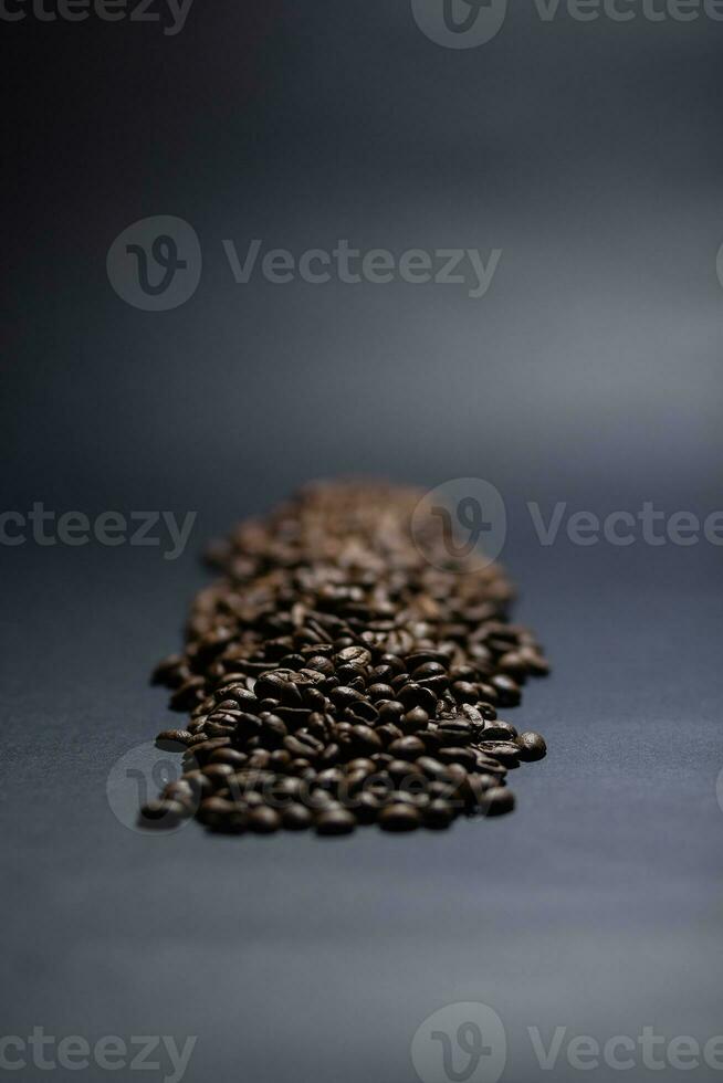 heap of coffee beans on black background photo