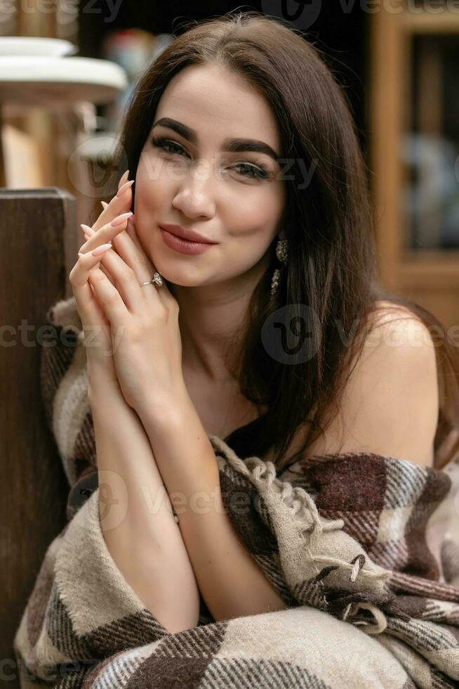 Beautiful girl resting and drinking coffee sitting in cafe on the terrace photo
