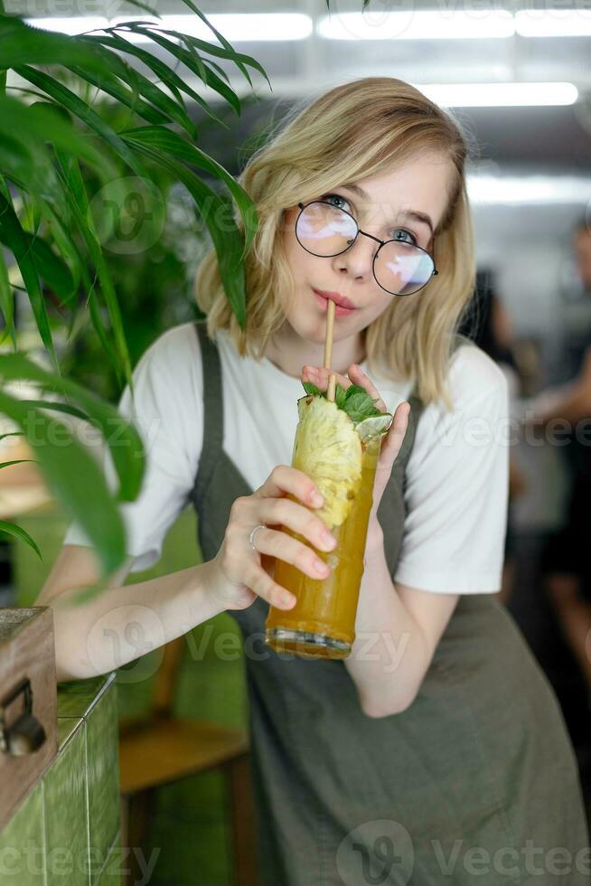 Close up young cheerful woman in dress happily looking in camera photo