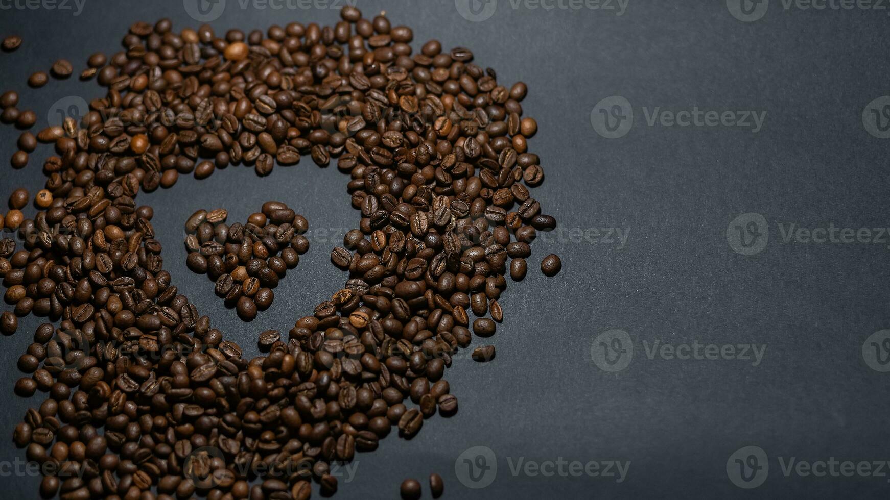 heap of coffee beans on black background photo