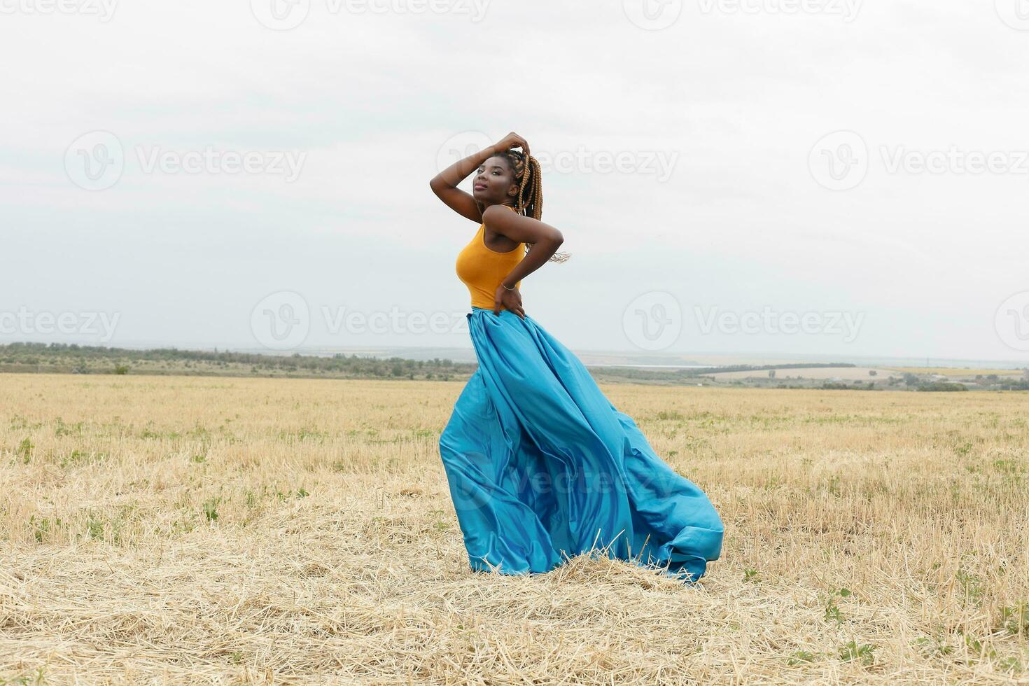 african american young woman having fun outdoors at sunset. photo