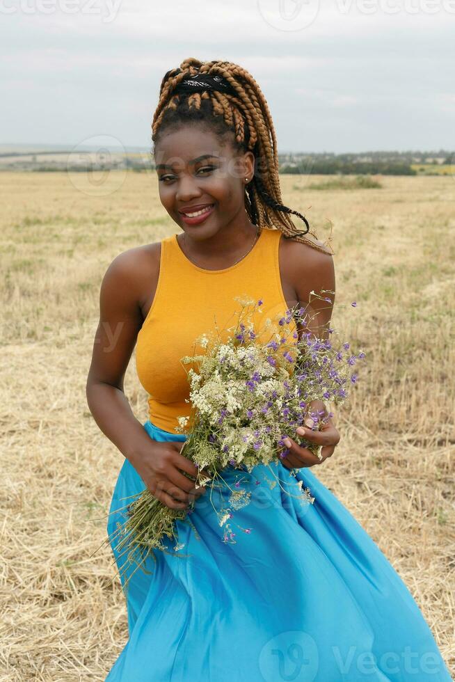 african american young woman having fun outdoors at sunset. photo