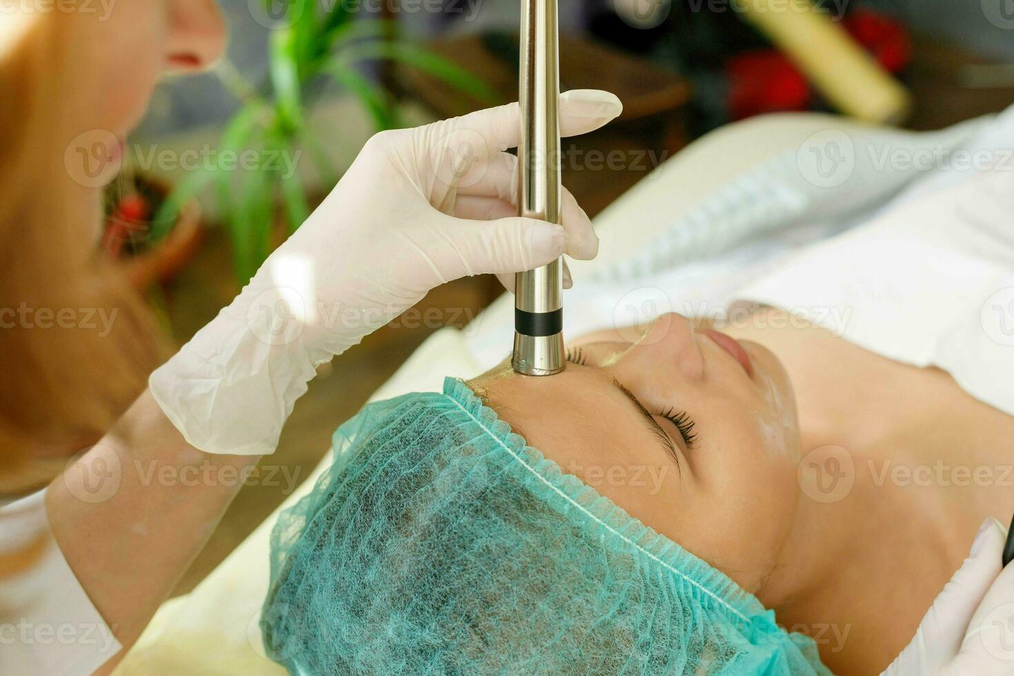 Cosmetologist makes the procedure microcurrent therapy beauty salon photo