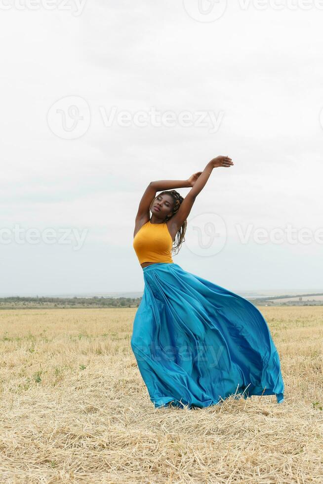 african american young woman having fun outdoors at sunset. photo