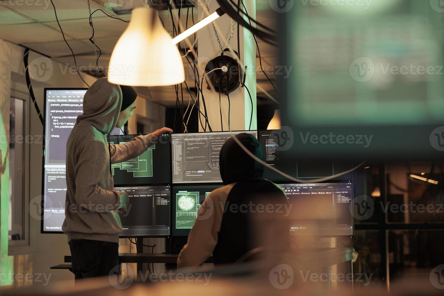 Diverse men working together to break security server, planning data breach with malware and trojan virus. Male hackers doing cyberterrorism attack and stealing passwords, phishing. photo