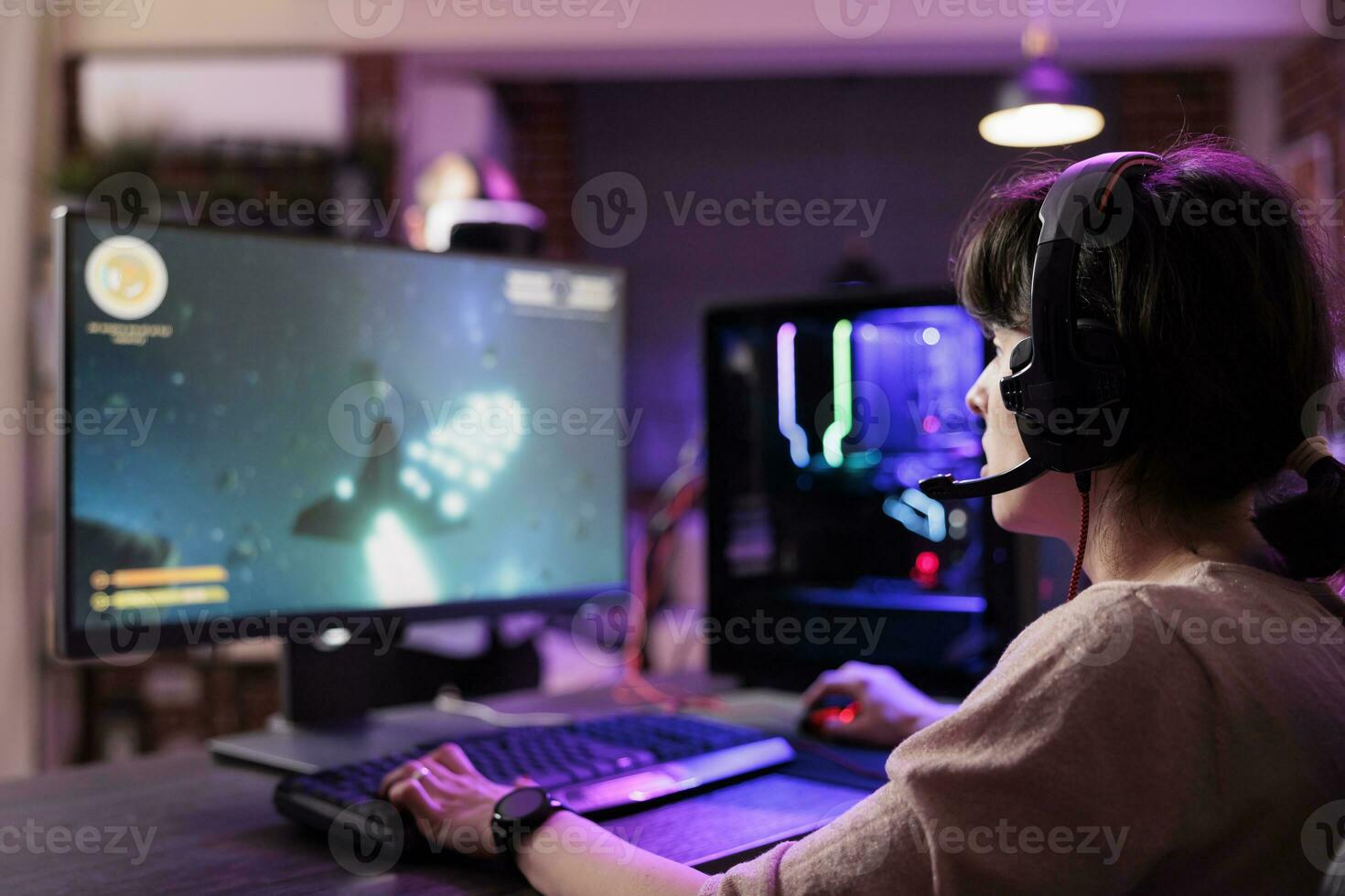 Professional gamer engaging in online competitive multiplayer tourney using cutting edge gaming system, captivating fans during live stream. Woman in rgb lights lit living room playing videogames photo