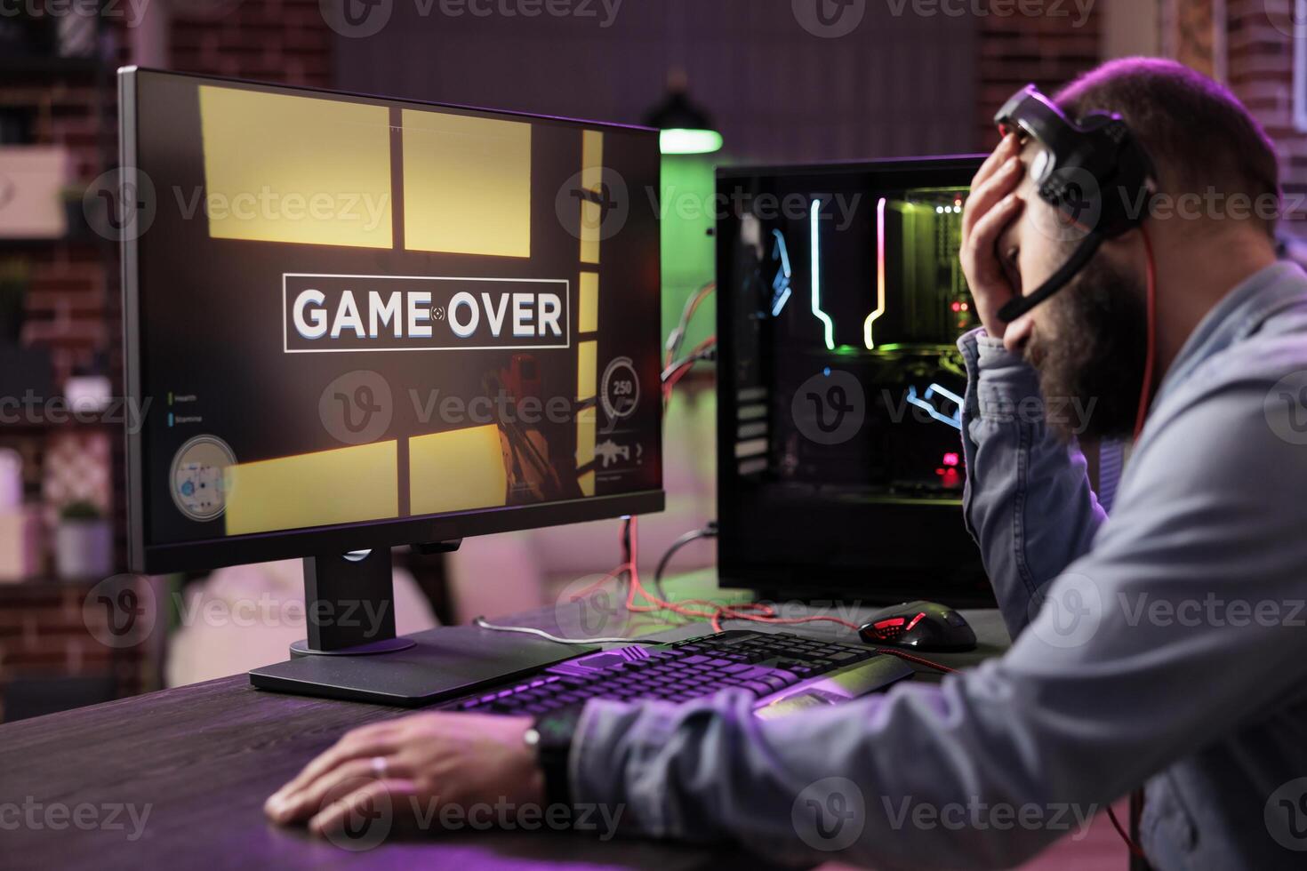 Gamer losing intense singleplayer spaceship arcade racing videogame, seeing game over screen on capable gaming computer system at home. Man being upset after being defeated on difficult game level photo