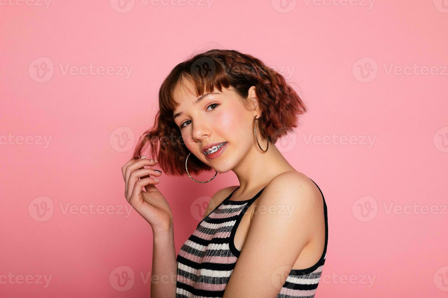 Image of young happy beautiful woman posing isolated over pink photo