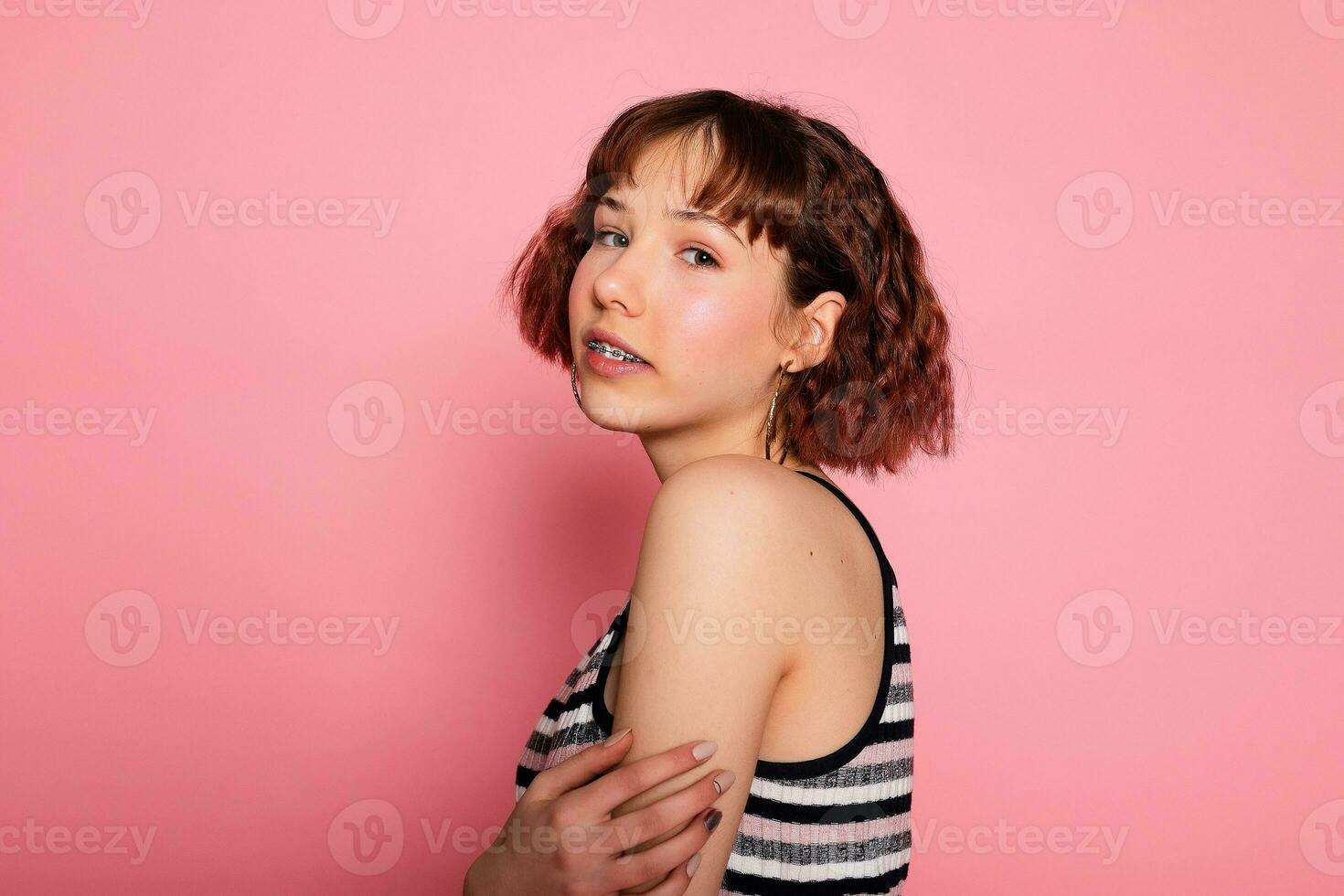 Image of young happy beautiful woman posing isolated over pink photo