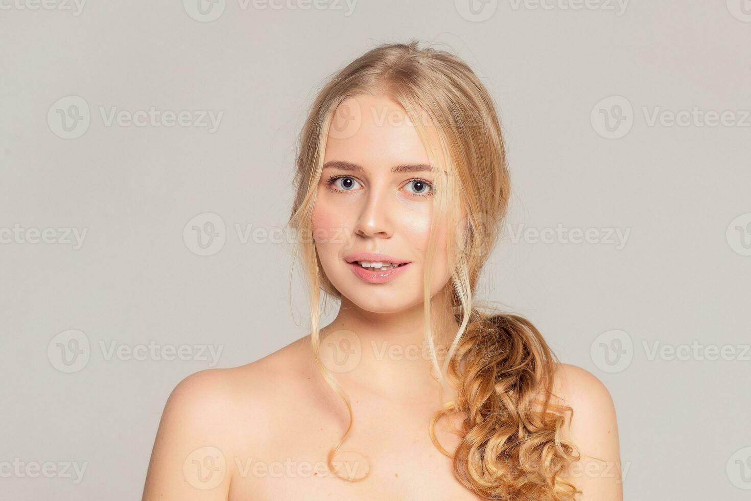 Beautiful Young Woman with Clean Fresh Skin touch own face photo